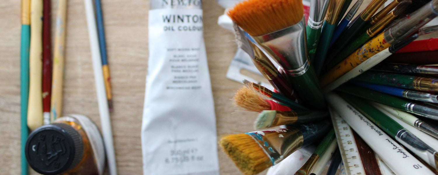 Close up of an artist's brushes and a tube of pain