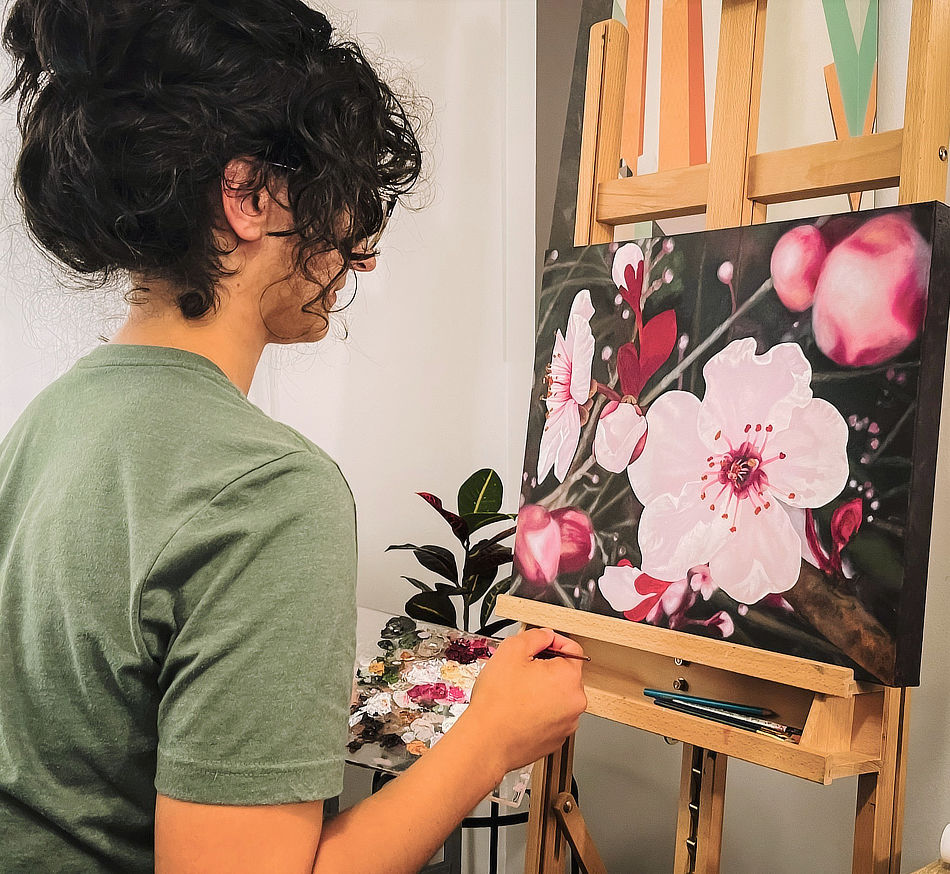 Artist working on a flower oil painting