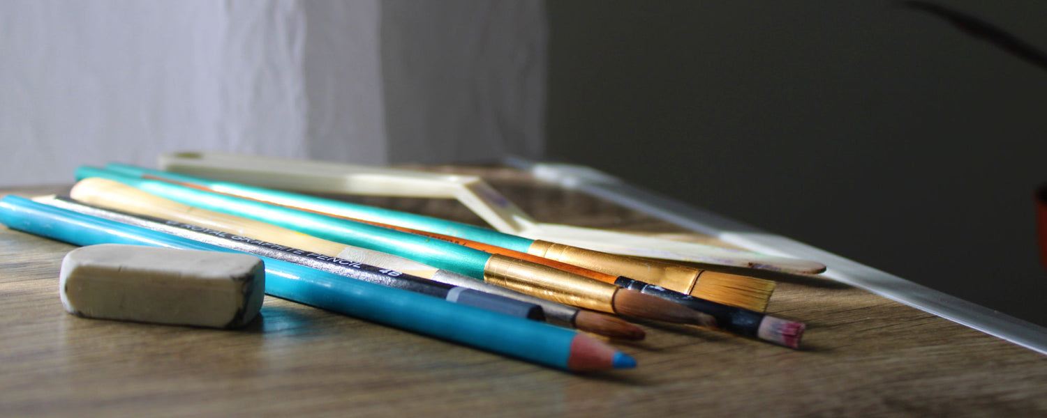 Close up of brushes and color pencils of an artist