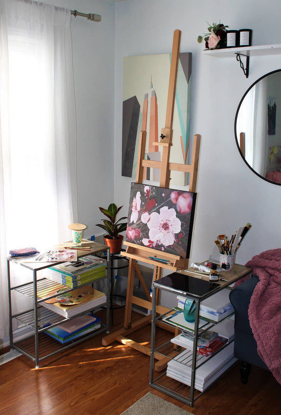 Studio of an oil painting artist showing an easel with a flower painting on it